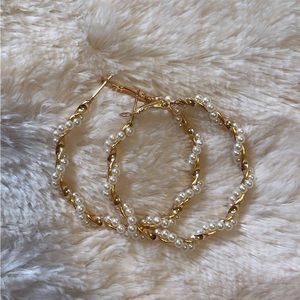 Gold hoop earrings with pearls wrapped around it